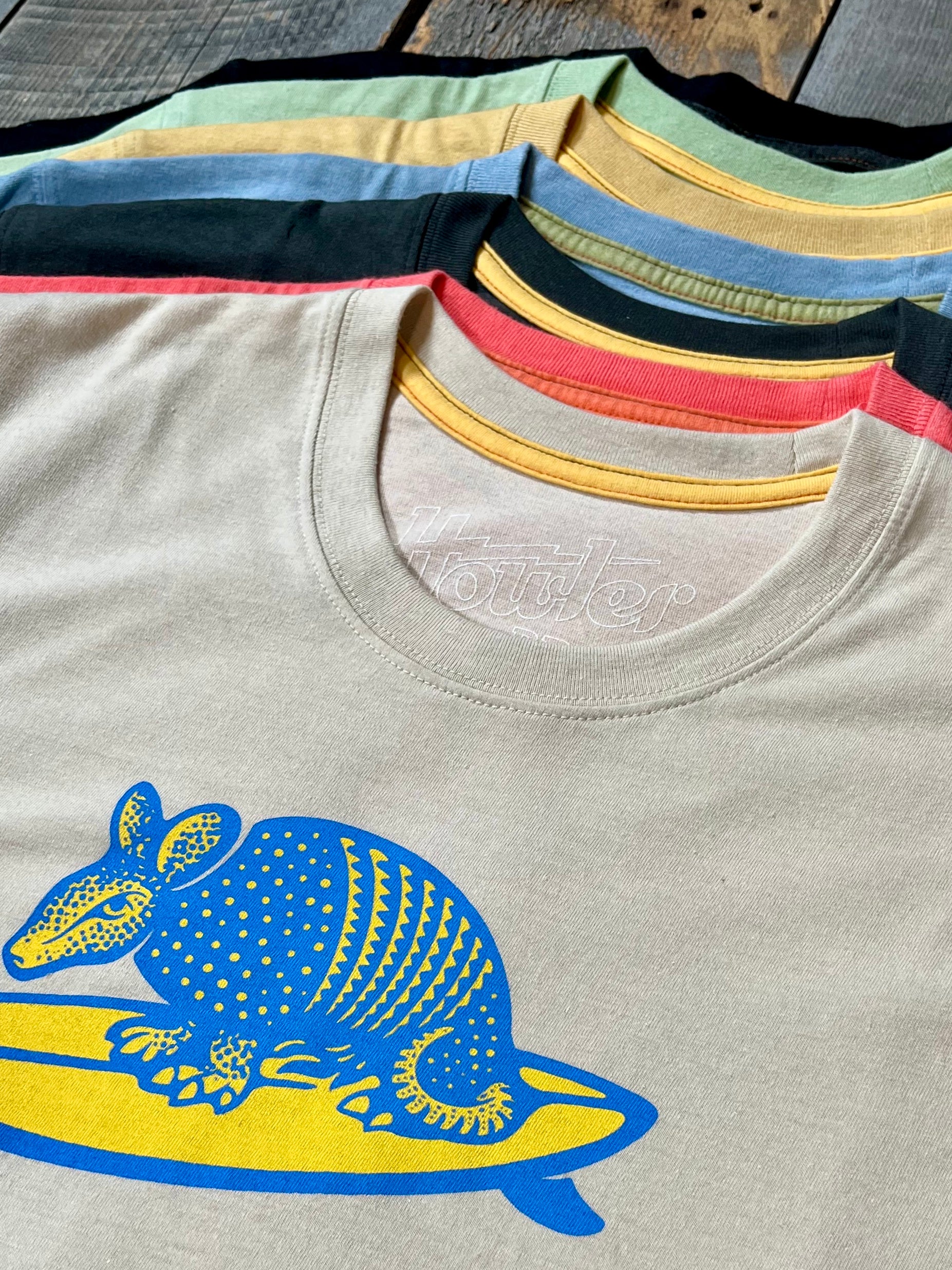 Picture of T-shirts on top of each other showing different variations.